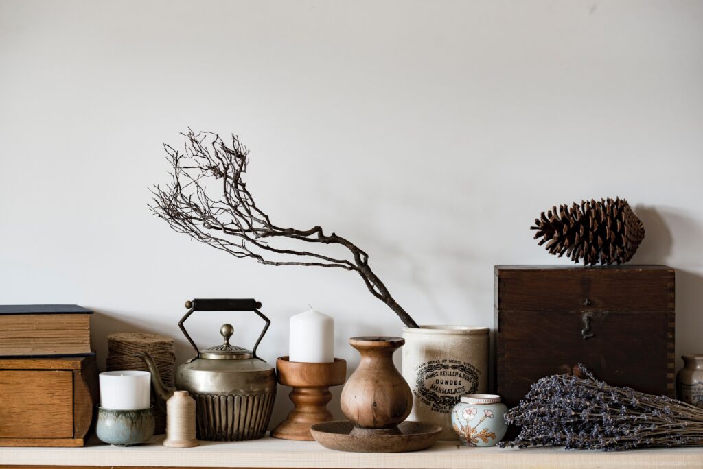 An assortment of earthy objects from dried plants to candles 