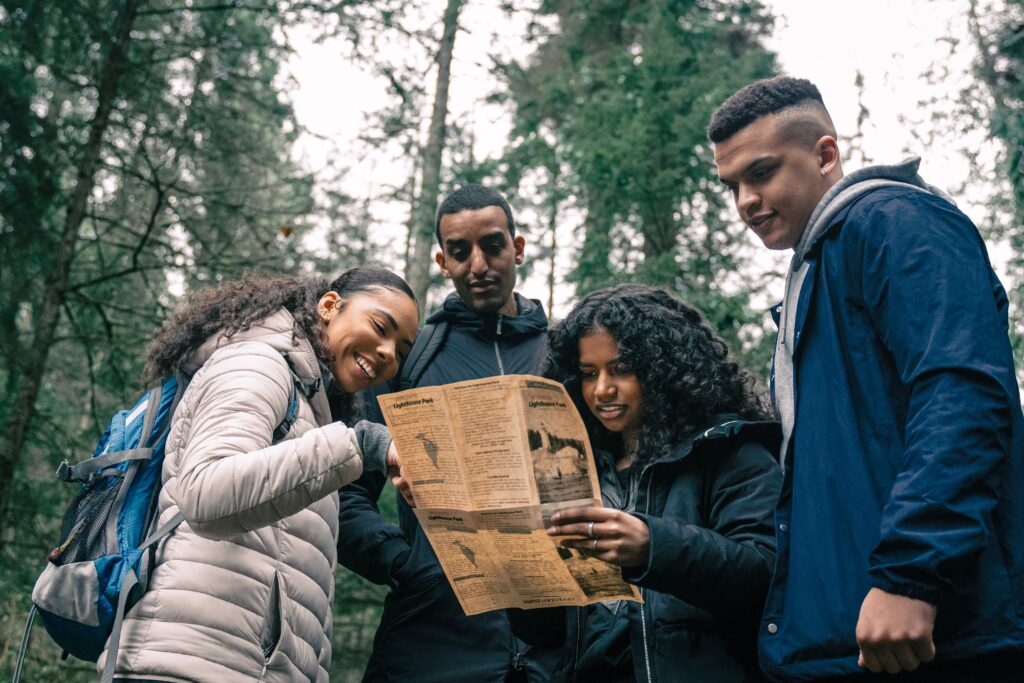 four people looking at a map