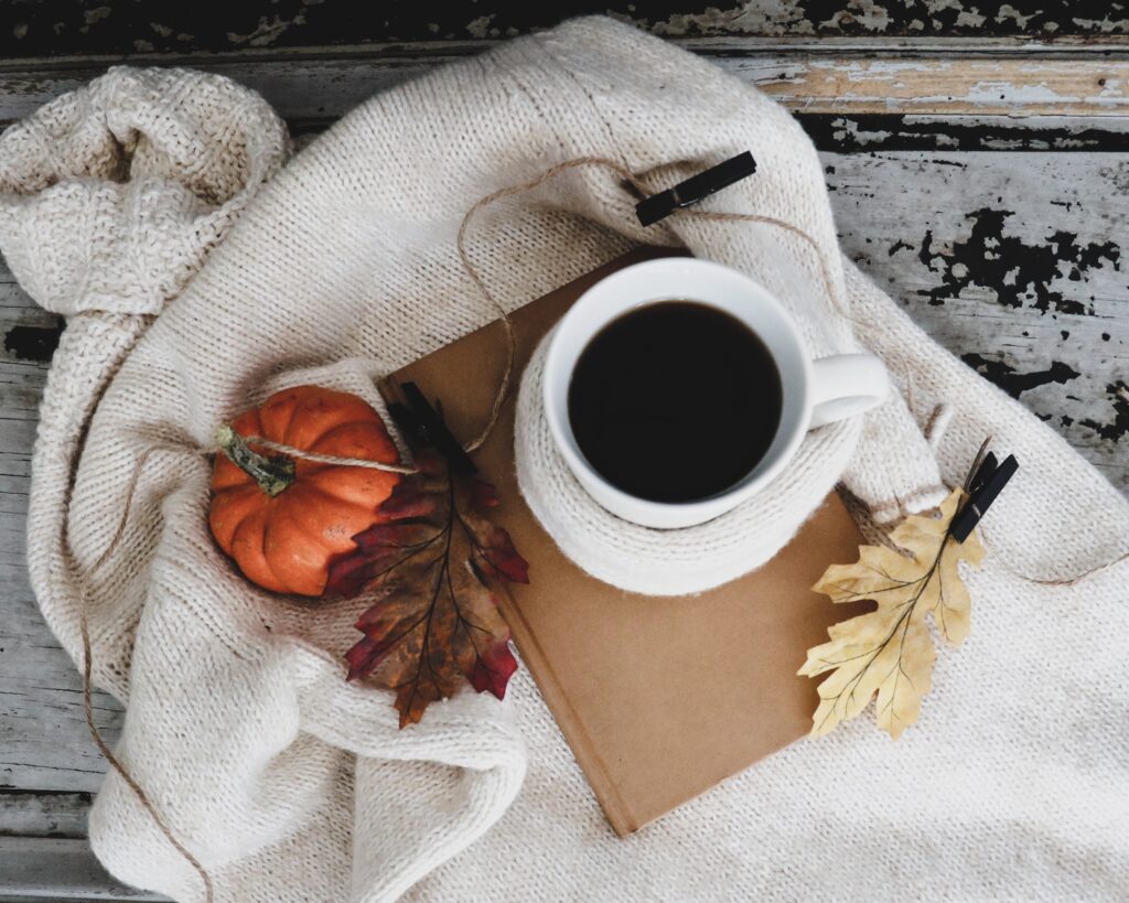 coffee and pumpkins and blankets set up for fall decorating