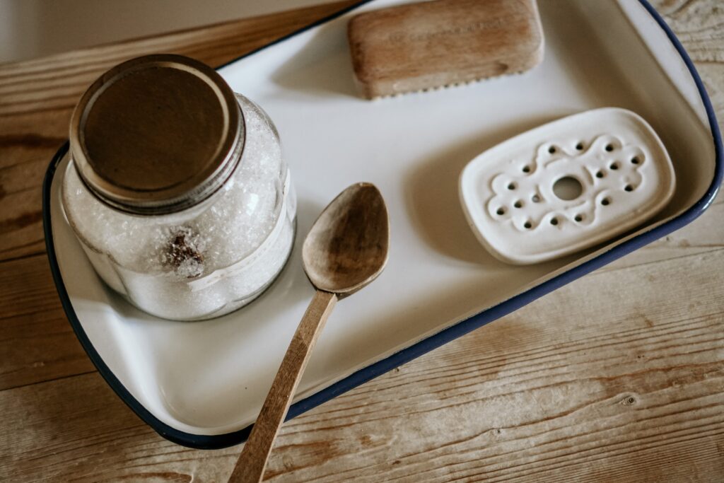 a tray with a mason jar and a spoon