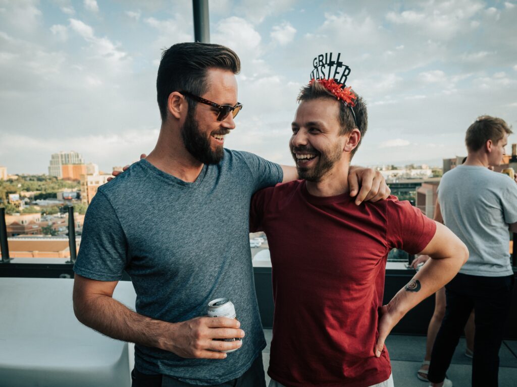 two men embrace at a NYE party