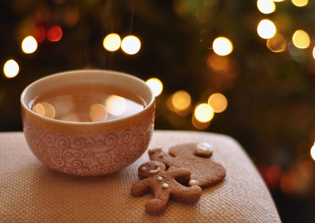 mug with a hot beverage and cookies next to the Christmas tree