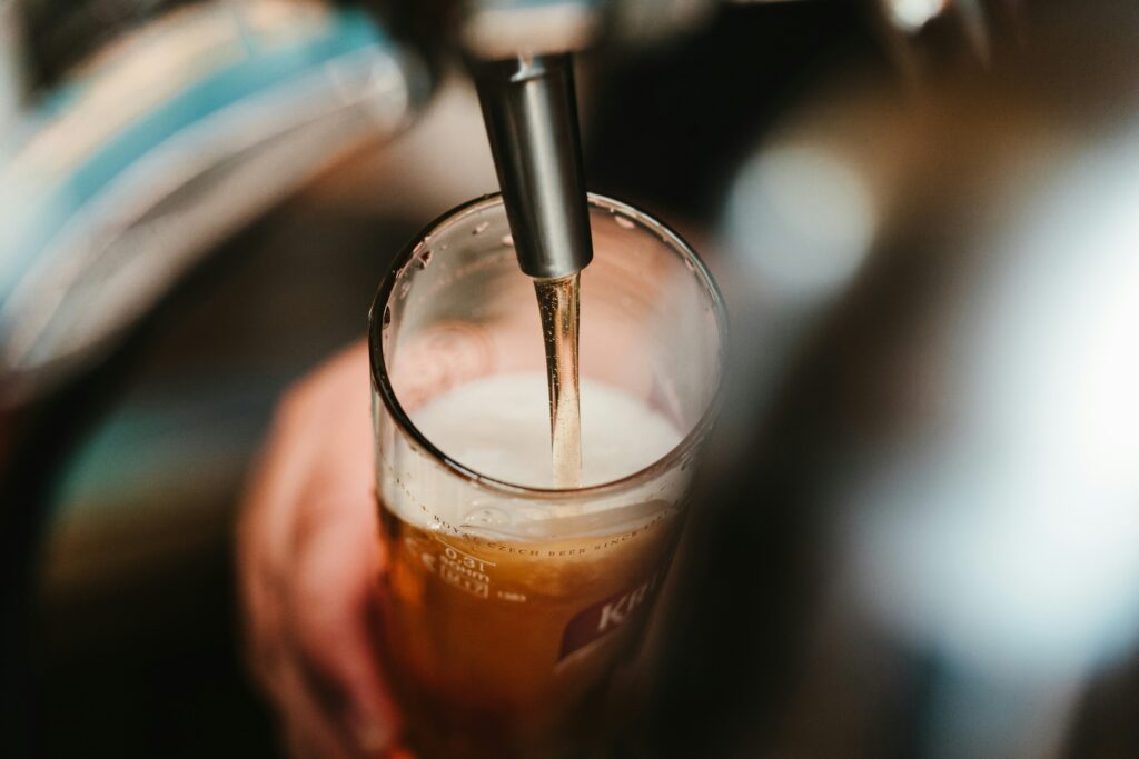 beer being poured into a glass from a tap in the Twin Cities craft breweries.